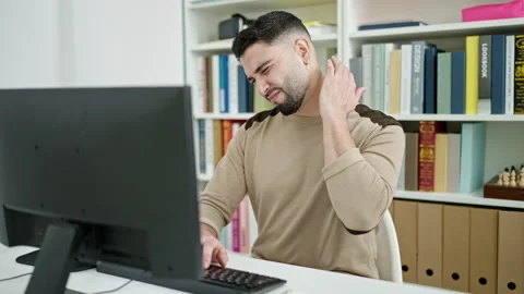 Young arab man student using computer stressed at university classroom Stock Footage 233419780