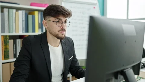 Young arab man student using computer stressed at university classroom 스톡 동영상 237290440