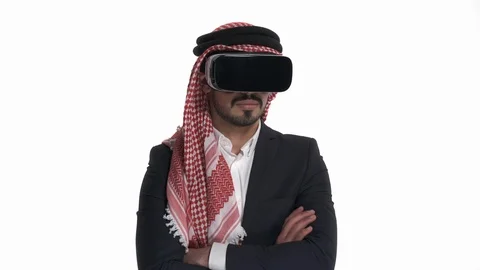 Young Arab man in virtual reality glasses looing to the sides. Isolated, on Stock Footage 125829506