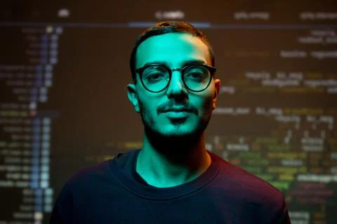 Young Arabian programmer against coding background Stock-Fotos