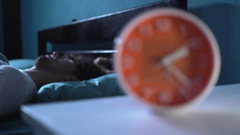 Young arabic man in bed suffering insomnia and sleep disorder thinking about his Stock Footage 243576267