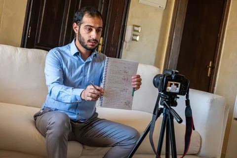 Young arabic man conducting a seminar from home Stock Photos