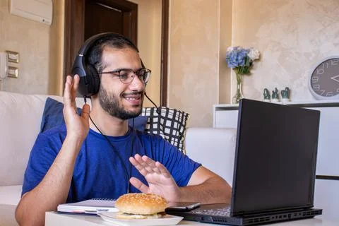 Young arabic man eating while working and  at home Stock Photos
