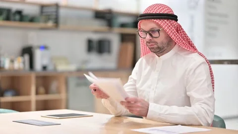 Young Arabic Man Reading Documents in Office 스톡 동영상 139770342