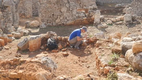 Young archeologist works on an archaeological site Stock Footage