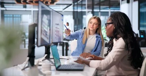 Young Architect And Engineer Explore Digital Building Model On Laptop Togethe Stock Photos
