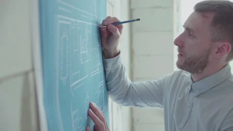 Young architect engineer works with blueprints Stock Footage 133056417