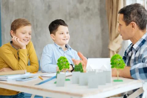 Young architect explaining his sons about his work Stock Photos
