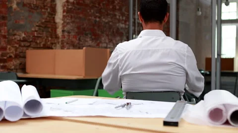 Young architect going over blueprints | Stock Video | Pond5