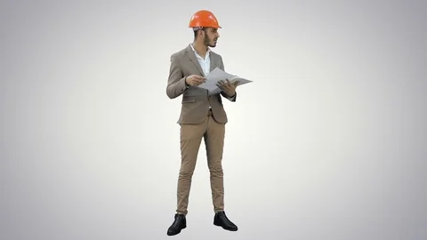 Young architect in helmet checking construction plans on white background Video stock 73641568