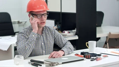 Young architect in helmet having important phone call Vídeos de archivo 71608255