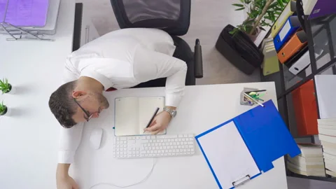Young architect looking at architectural projects on the phone in his office. 스톡 동영상 224971318