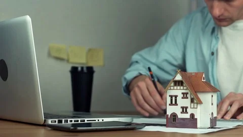 Young architect using pencil and metal ruler creating housing project Stock Footage 81881822