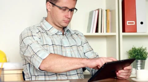 Young architect working on tablet computer and documents, steadicam shot HD Stock Footage