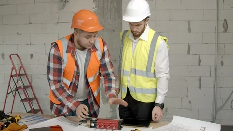 Young architects checking equipment on construction site Stock Footage 125457608