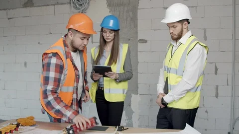 Young architects checking new blueprints Stock Footage 125457557