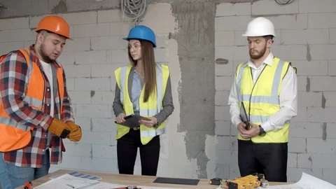 Young architects having discussion on construction site Stock Footage 125457405