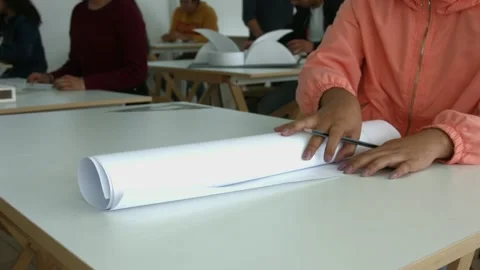 Young architecture student opens plans in a drawing board. Students of archit Stock Footage 144508369