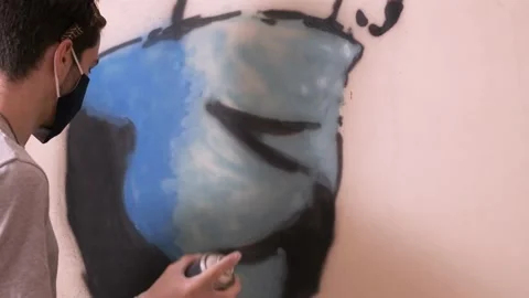 Young artist creating social distancing graffiti message Stock Footage 142090697