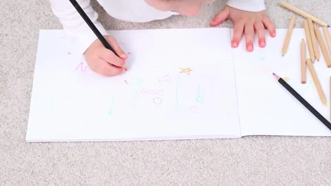 Young artist immersed in creativity, drawing on a bright surface Stock-Footage 295355737