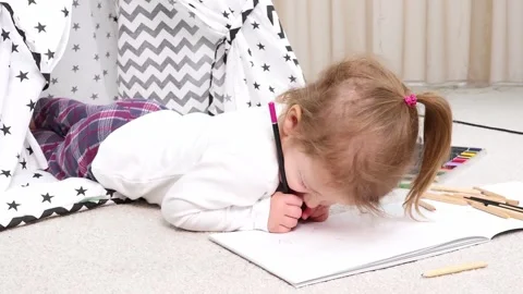 Young artist immersed in creativity inside cozy play tent 스톡 동영상 295354680