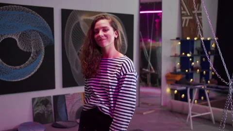 A young artist is posing for the camera and smiling Stock Footage 155250480