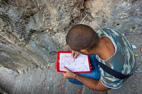 Young artist while drawing. Stock Photos
