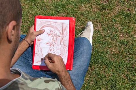 Young artist while drawing. Stock Photos