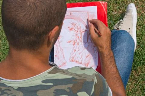 Young artist while drawing. Stock Photos