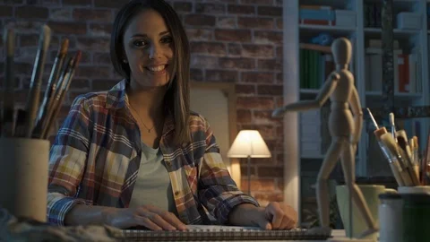 Young artist working in her studio and sketching Stock Footage 90371491
