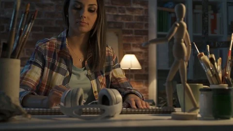 Young artist working in her studio and sketching Stock Footage 90371534