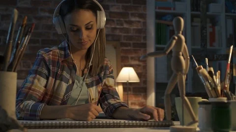 Young artist working in her studio and sketching Stock Footage 90371579