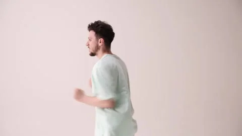 Young artistic man dressed casual, oversized stylish outfit dancing break dance Stock Footage 303347885
