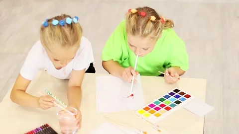 Young artists explore creativity with vibrant paint and playful energy Stock-Footage 296332595