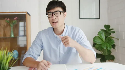 Young Asia businessman using computer talk to colleagues in video call. Vídeo Stock 136848071