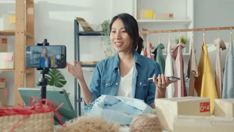 Young Asia lady designer using mobile phone receiving purchase order at shop. Stock Footage 148053066