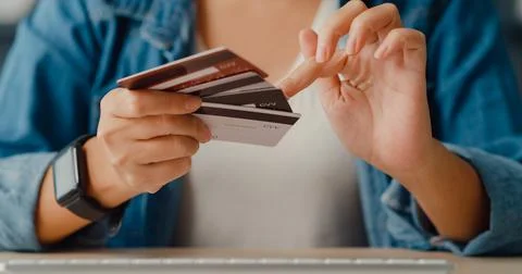 Young asia lady using computer order online shopping product and paying bil.. Stock Photos