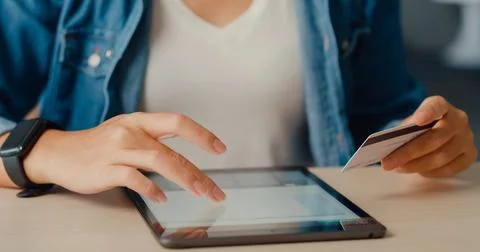 Young asia lady using tablet order online shopping product and paying bills.. Stock Photos