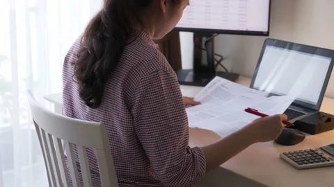 Young Asian accounting validating document Stock Footage 146951080