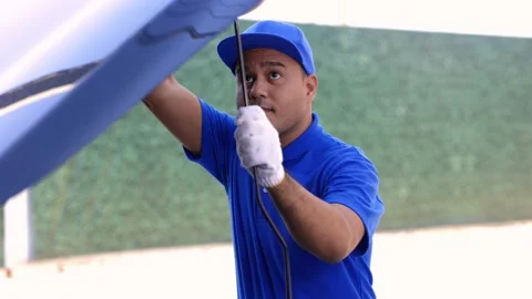 A young Asian auto mechanic opens the bonnet. To check for engine damage And per Stock Footage 152747971