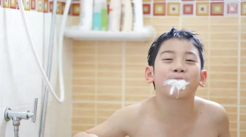 Young asian boy brushing teeth in bathroom Stock Footage 49596951
