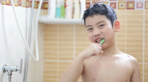 Young asian boy brushing teeth in bathroom Stock Footage 49597791