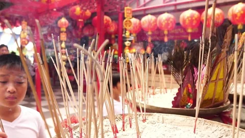  Young Asian boy a burning put incease in a sand pot at chinese temple Stock Footage 90507832