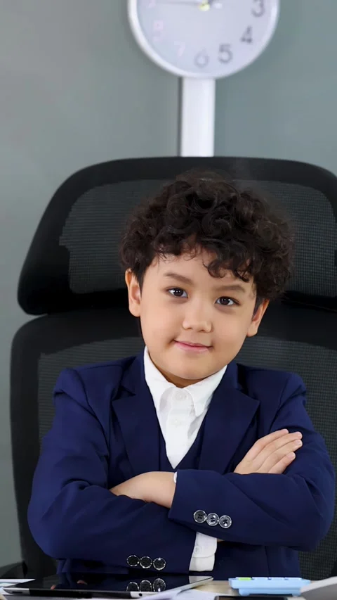 Young Asian Boy in Business Suit Sitting at Office Desk with Crossed Arms Stock Footage 338155553