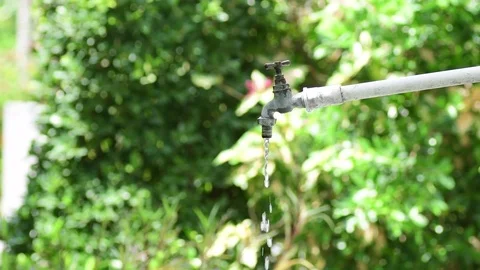 Young Asian boy close the opening faucet to safe water Stock Footage 74537519