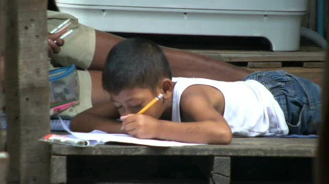 Young Asian Boy Doing Homework In The Slums 스톡 동영상 740827