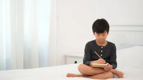 Young Asian boy doing homework and get idea Stock Footage 127667888