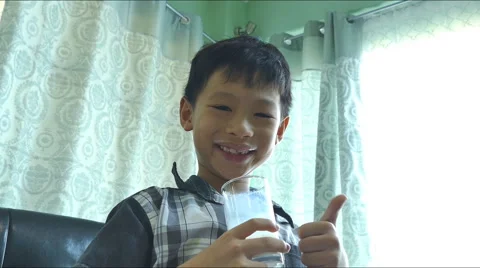 Young Asian boy drinking a glass of milk Stock Footage 55183653