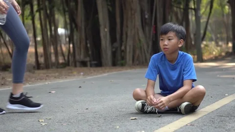 Young Asian boy get a bottle of water from his sister Stock Footage 124367132