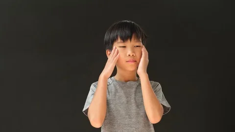 Young Asian boy has headache and eye problem. Stock Footage 126977295